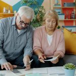 Older couple going through financial papers at home