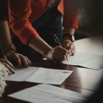 Person signing a legal document