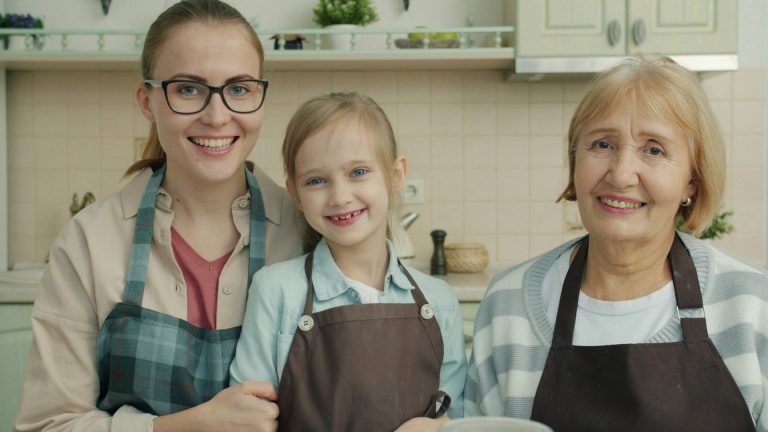 Three generations of women together in a family kitchen
