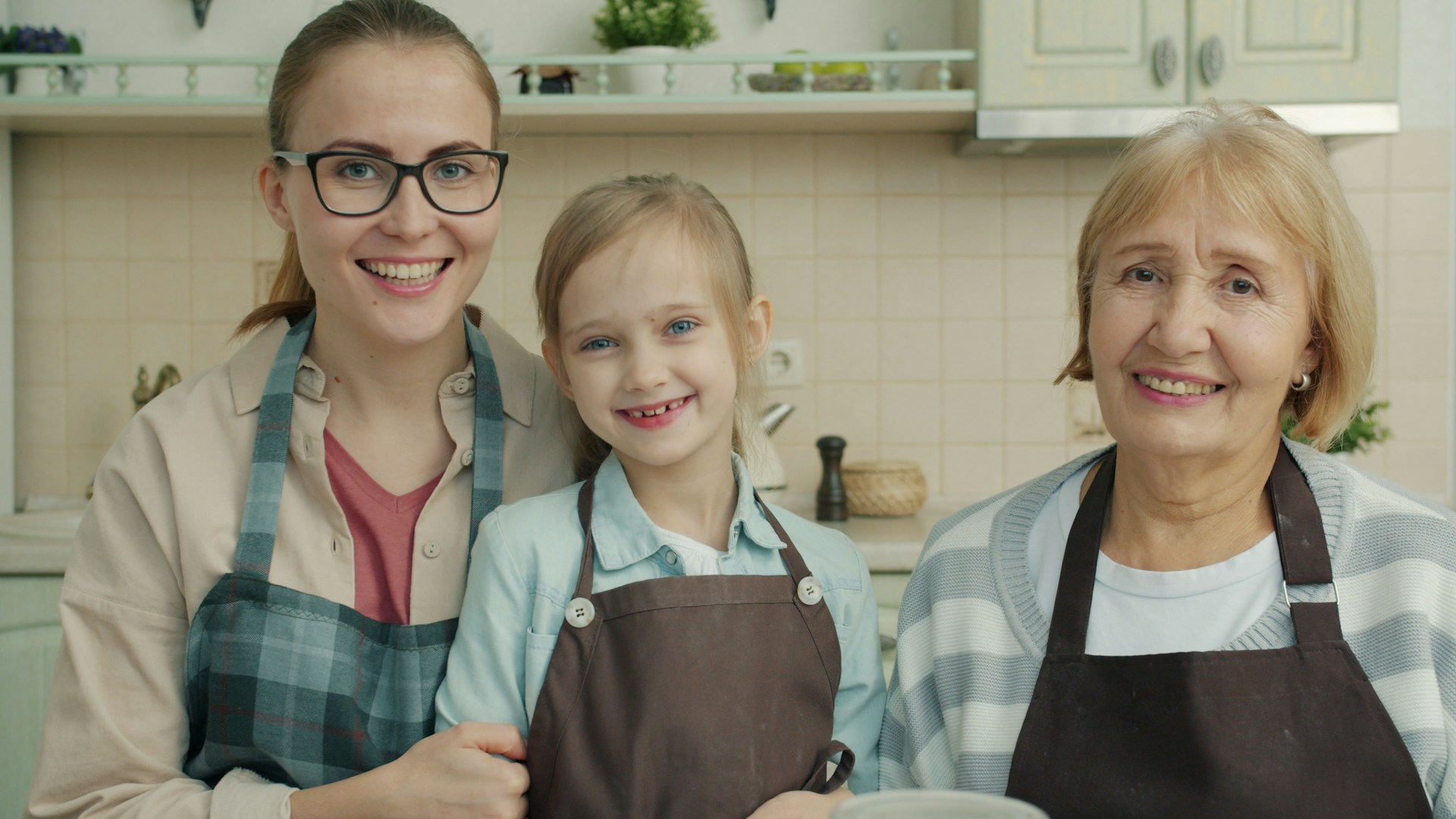 Three generations of women together in a family kitchen