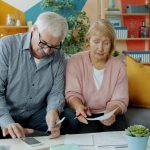 Older couple going through financial documents at home