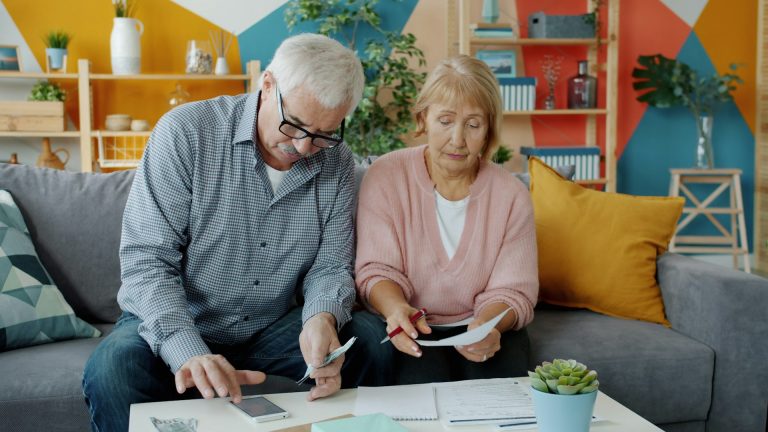 Older couple going through financial documents at home