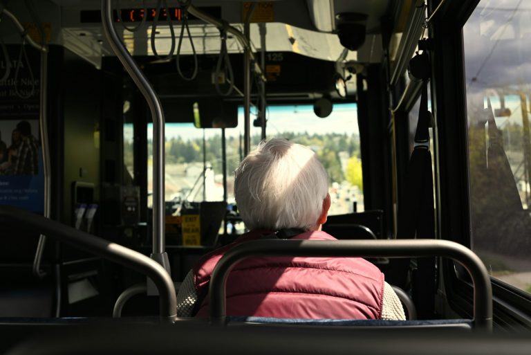 Older passenger riding a bus