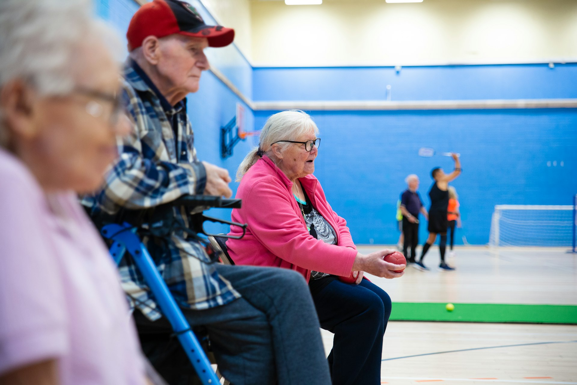 Group of seniors playing a game together in a community hall