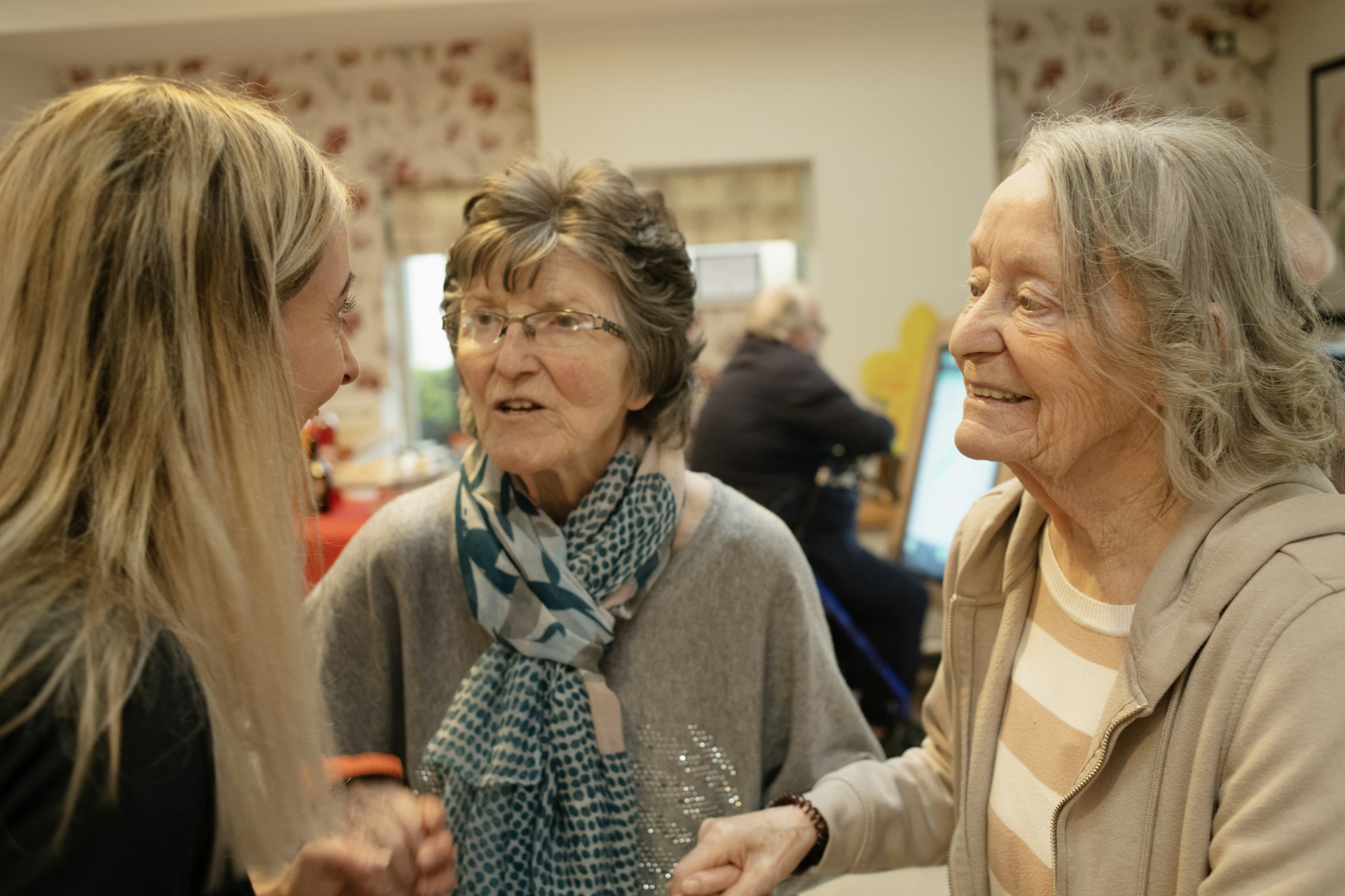 Three older women chatting together